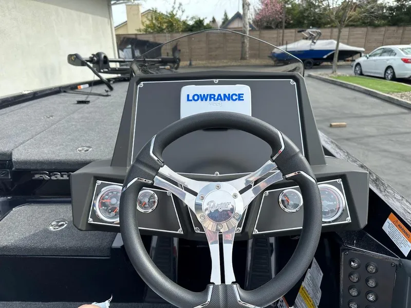 Slide: The Image of 2024 Ranger Z518 boat dashboard with Lowrance electronics and steering wheel. - 16