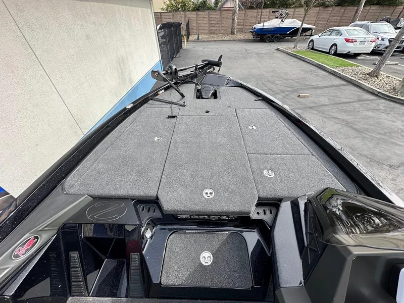 Slide: The Image of 2024 Ranger Z518 boat deck with storage compartments and fishing equipment. - 19