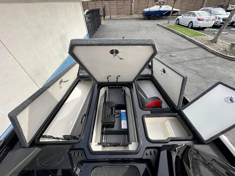 Slide: The Image of 2024 Ranger Z518 boat storage compartments open, showcasing organized interior space. - 25