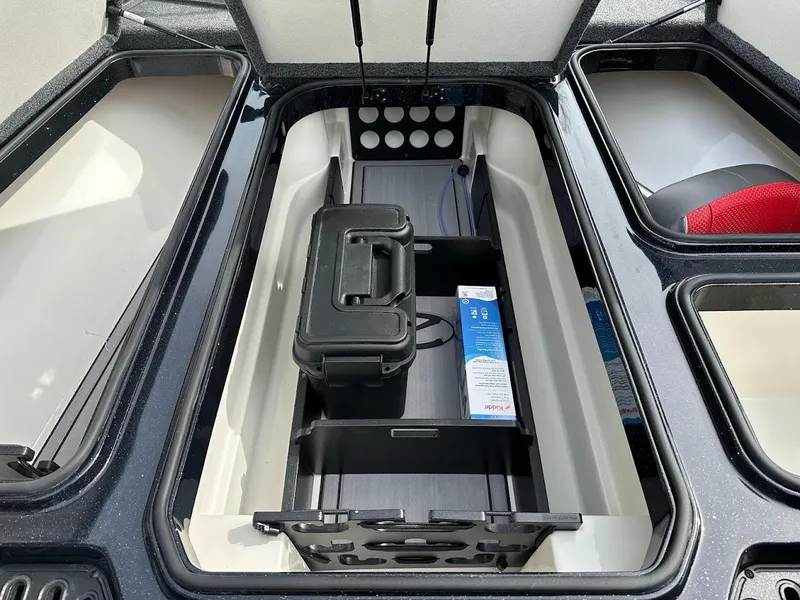 Slide: The Image of 2024 Ranger Z518 storage compartment with organized fishing gear and tackle box. - 27