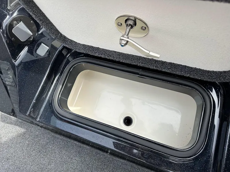 Slide: The Image of 2024 Ranger Z518 boat compartment with latch, featuring a sleek black and white design. - 29