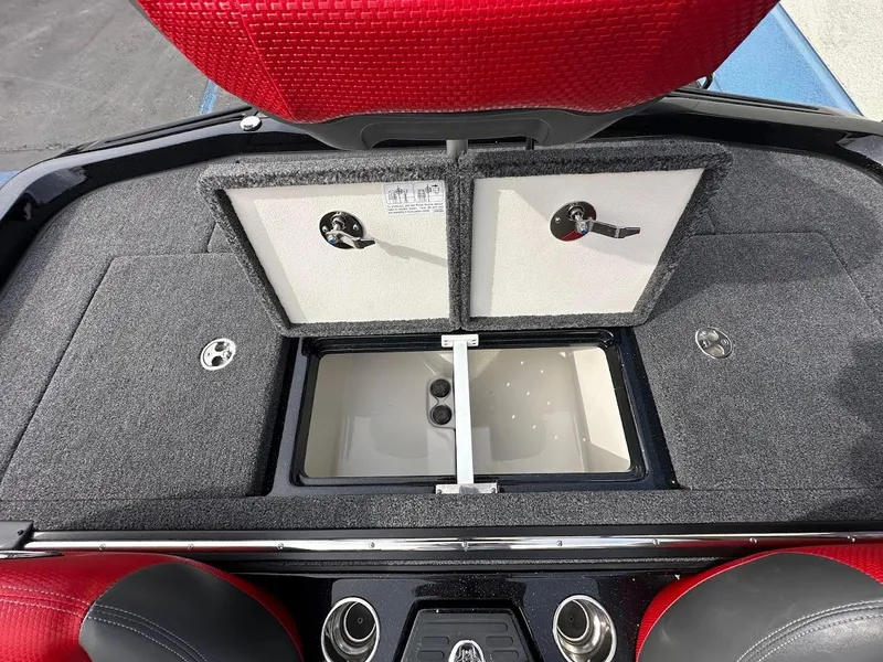 Slide: The Image of 2024 Ranger Z518 boat storage compartments with red seating and gray carpet. - 31