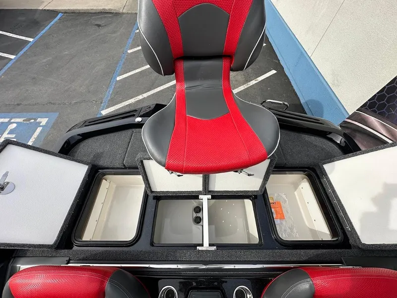 Slide: The Image of 2024 Ranger Z518 boat interior with red and gray seat, storage compartments, and sleek design. - 35