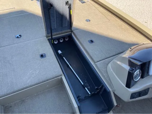 Slide: The Image of 2022 G3 Sportsman 1910 boat storage compartment with open hatch and rod holder. - 9