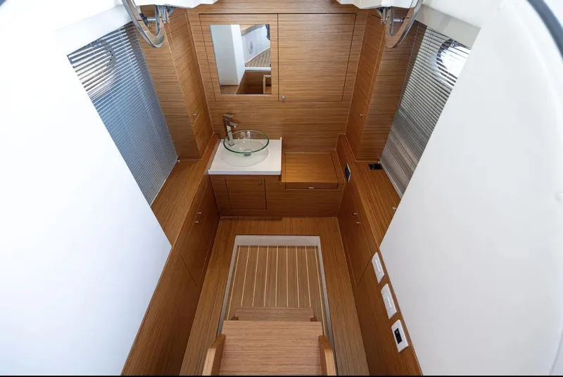 Slide: The Image of 2022 Comitti Isola I-33 interior with modern wood finish and sleek design. - 11