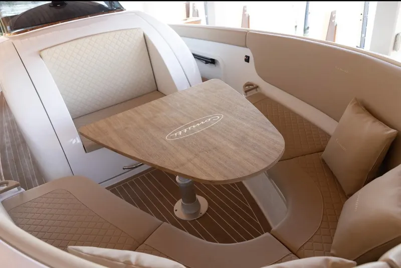 Slide: The Image of Luxurious interior of 2022 Comitti Isola I-33 boat with elegant seating and table. - 16