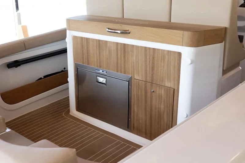 Slide: The Image of Interior of 2022 Comitti Isola I-33 boat with wood paneling and built-in storage. - 7