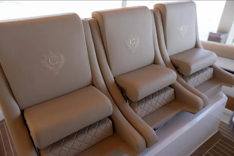 Slide: The Image of Luxurious beige seating on 2022 Comitti Isola I-33 boat, featuring elegant embroidery and quilted design. - 8