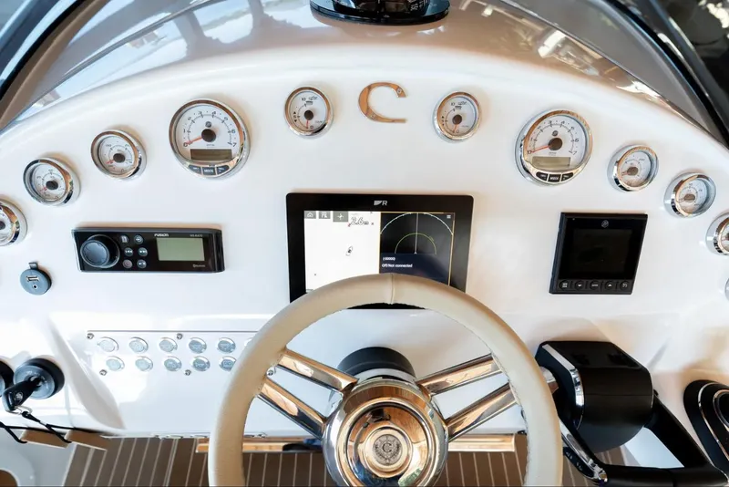 Slide: The Image of 2022 Comitti Isola I-33 dashboard with gauges, steering wheel, and navigation display. - 9