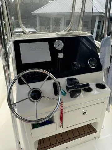 Slide: The Image of 2023 Bulls Bay 200CC boat console with steering wheel and gauges. - 11