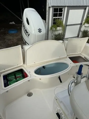 Slide: The Image of 2023 Bulls Bay 200CC boat interior with Suzuki engine, storage compartments, and seating area. - 16