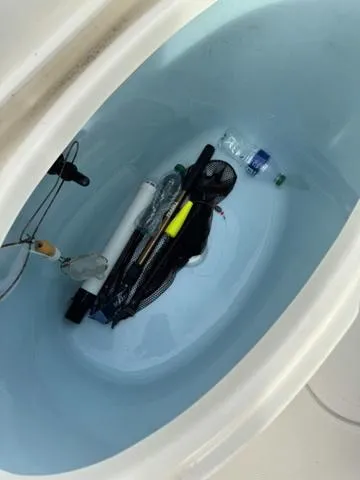 Slide: The Image of Bulls Bay 200CC 2023 boat storage compartment with fishing gear and water bottle. - 19