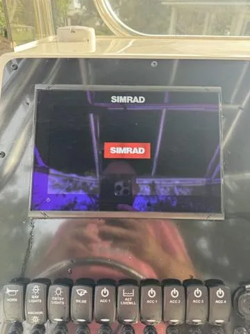 Slide: The Image of Simrad display on 2023 Bulls Bay 200CC boat dashboard with control buttons. - 24