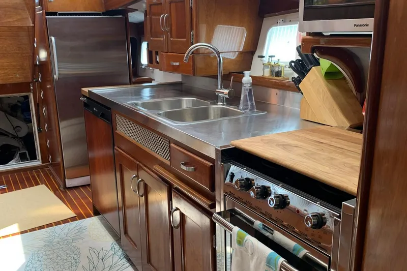 Slide: The Image of 1971 Whiticar Sportfish kitchen with stainless steel sink, wooden cabinets, and modern appliances. - 10