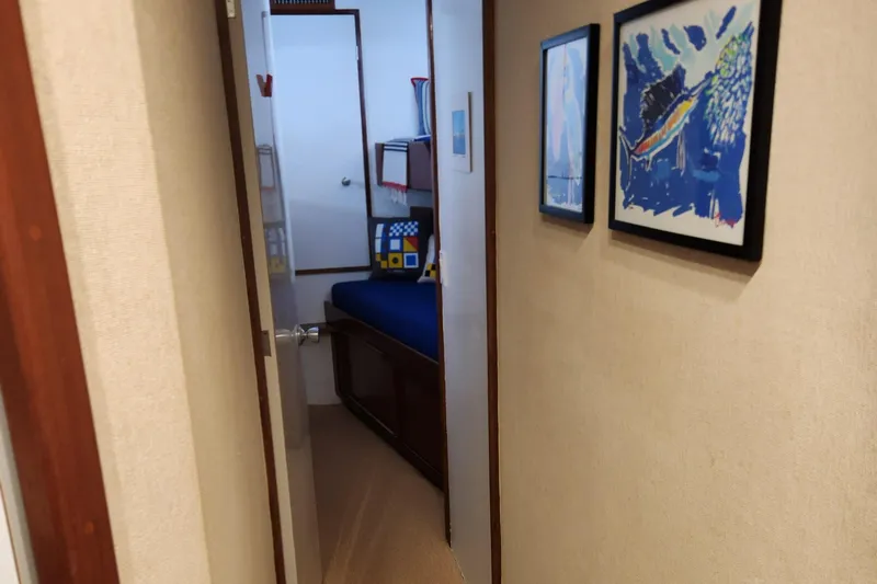 Slide: The Image of Hallway view inside a 1971 Whiticar Sportfish boat, featuring framed artwork and a cozy cabin. - 21