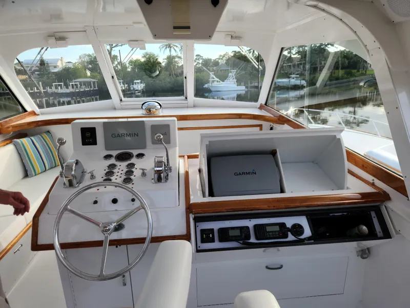 Slide: The Image of 1971 Whiticar Sportfish boat interior with Garmin navigation system and wooden accents. - 25