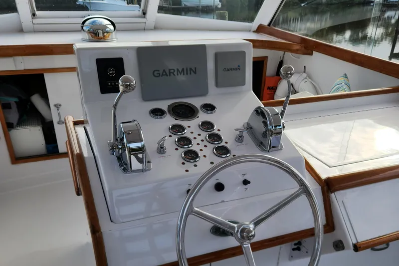 Slide: The Image of 1971 Whiticar Sportfish helm with Garmin navigation system and classic controls. - 26