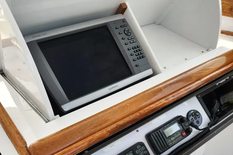 Slide: The Image of 1971 Whiticar Sportfish boat dashboard with Garmin GPS and communication equipment. - 27