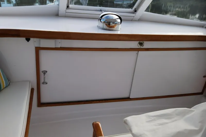 Slide: The Image of 1971 Whiticar Sportfish interior with wooden trim and storage compartment. - 30