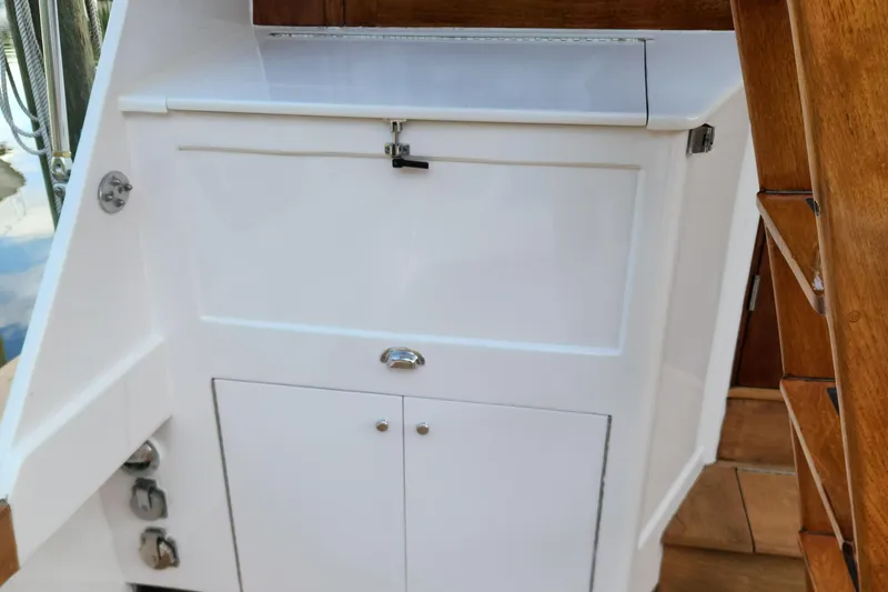 Slide: The Image of 1971 Whiticar Sportfish boat interior with white storage cabinet and wooden stairs. - 32