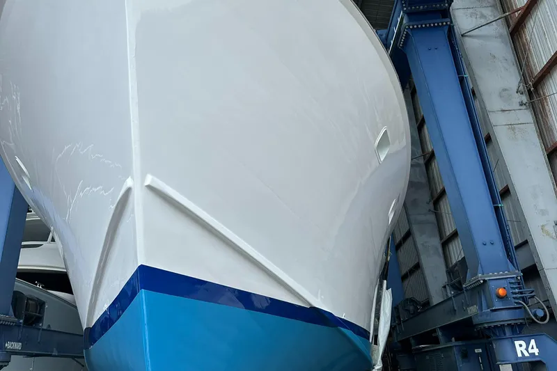 Slide: The Image of 1971 Whiticar Sportfish boat in dry dock, showcasing its sleek hull design. - 37