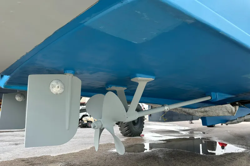 Slide: The Image of 1971 Whiticar Sportfish boat underside showing propeller and rudder in dry dock. - 38