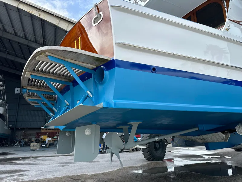 Slide: The Image of 1971 Whiticar Sportfish boat in a shipyard, showcasing its blue hull and propeller. - 39