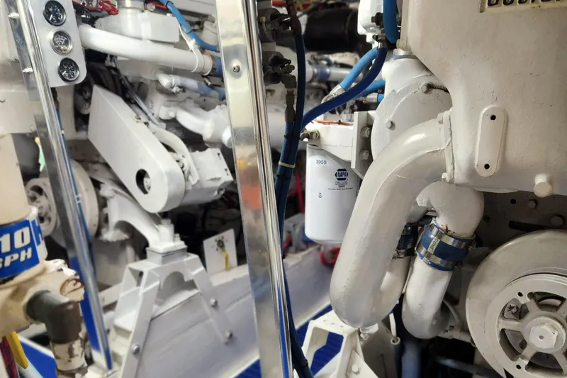 Slide: The Image of Engine room of a 1971 Whiticar Sportfish boat, showcasing mechanical components and piping. - 46