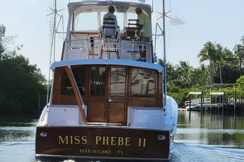 Slide: The Image of 1971 Whiticar Sportfish boat "Miss Phebe II" cruising in a serene waterway. - 5