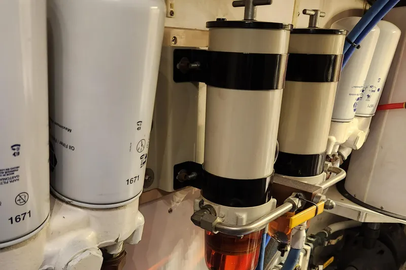 Slide: The Image of Engine components of a 1971 Whiticar Sportfish boat, featuring fuel filters and oil filters. - 51