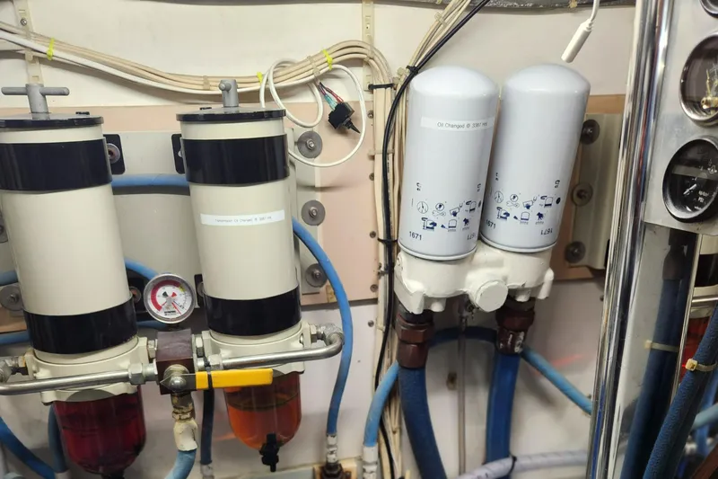 Slide: The Image of Engine room of a 1971 Whiticar Sportfish boat showing fuel filters and piping. - 52