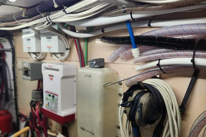 Slide: The Image of Engine room of a 1971 Whiticar Sportfish boat with wiring and equipment. - 53