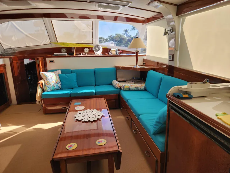 Slide: The Image of Interior of a 1971 Whiticar Sportfish yacht with blue seating and wooden accents. - 6