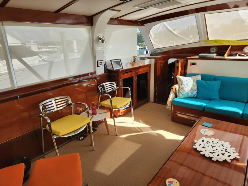 Slide: The Image of Interior of a 1971 Whiticar Sportfish yacht with modern seating and wooden accents. - 8