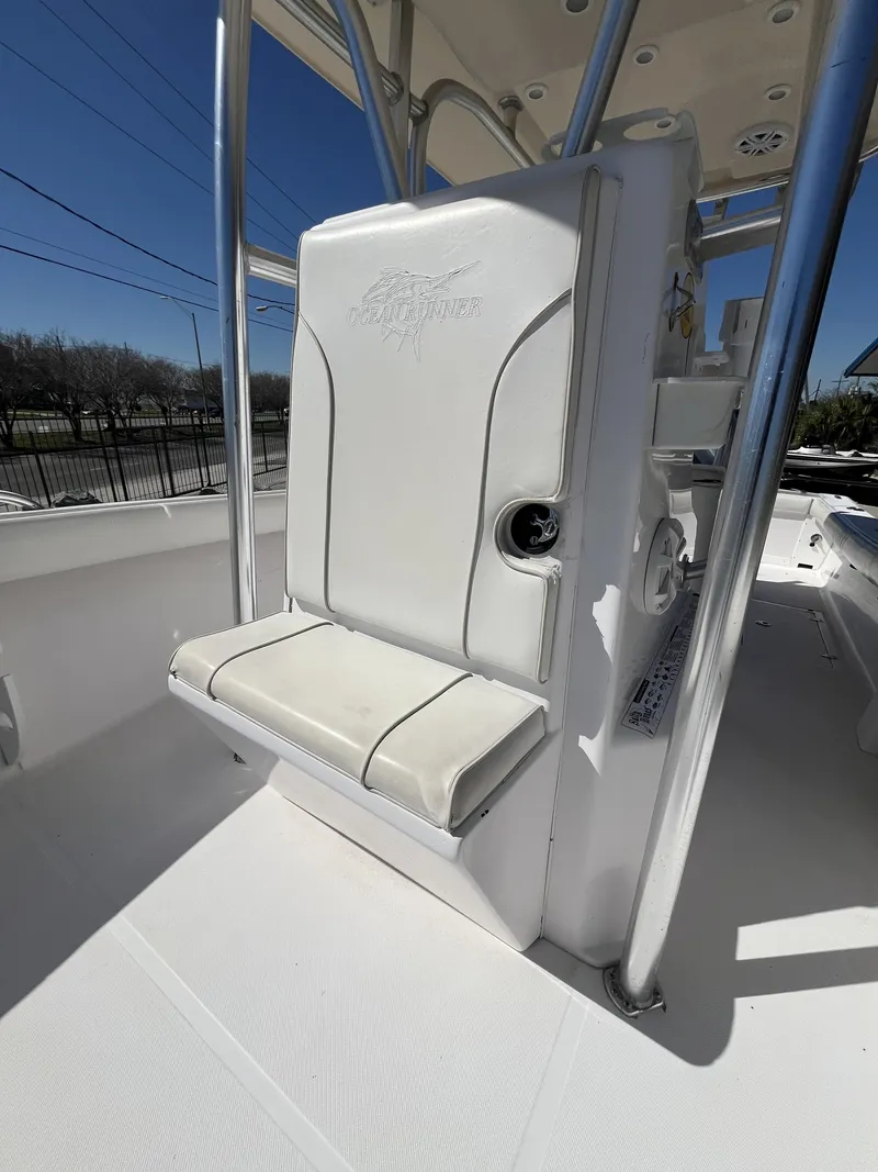 Slide: The Image of Ocean Runner 29 cc 2010 boat seat with white upholstery and stainless steel frame. - 10