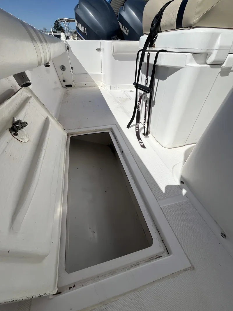 Slide: The Image of Open storage compartment on 2010 Ocean Runner 29 cc boat deck. - 11