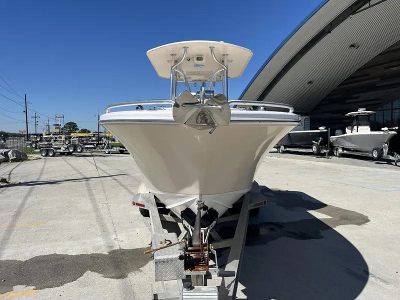 Slide: The Image of 2010 Ocean Runner 29 cc boat on trailer, parked outdoors near a large building. - 12