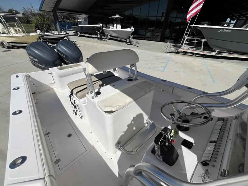 Slide: The Image of 2010 Ocean Runner 29 cc boat with dual Yamaha engines, docked outdoors. - 18
