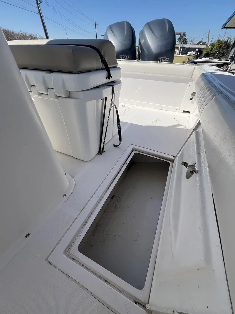 Slide: The Image of 2010 Ocean Runner 29 cc boat interior with storage compartment and dual engines. - 23