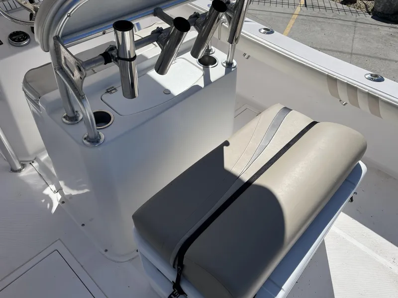 Slide: The Image of Ocean Runner 29 cc 2010 boat interior with rod holders and cushioned seating. - 24