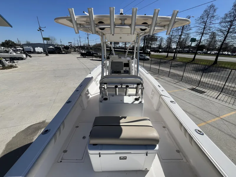 Slide: The Image of 2010 Ocean Runner 29 cc boat with center console and seating, parked outdoors. - 4
