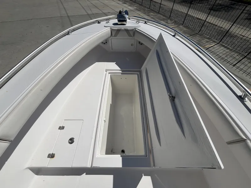 Slide: The Image of 2010 Ocean Runner 29 cc boat with open storage compartment on deck. - 8