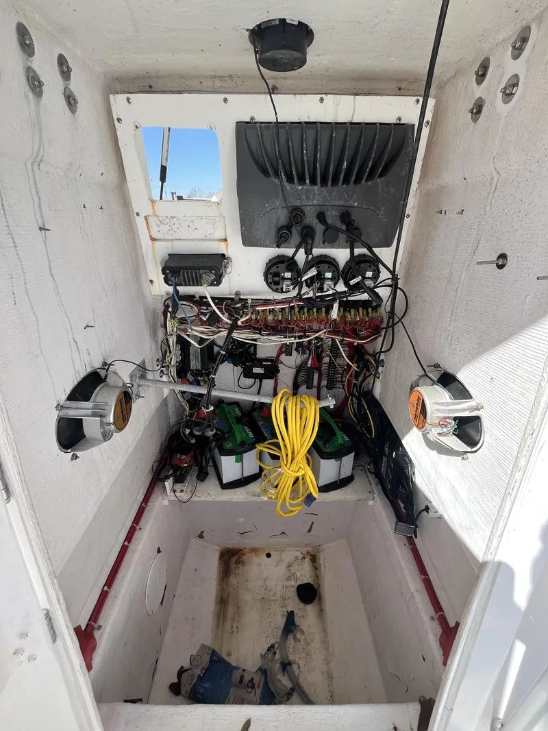 Slide: The Image of Interior view of a 2010 Ocean Runner 29 cc boat's electrical wiring and battery setup. - 9