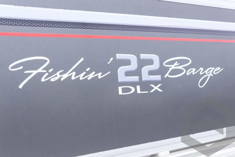 Slide: The Image of 2015 Sun Tracker Fishin' Barge 22 DLX logo on boat exterior. - 11