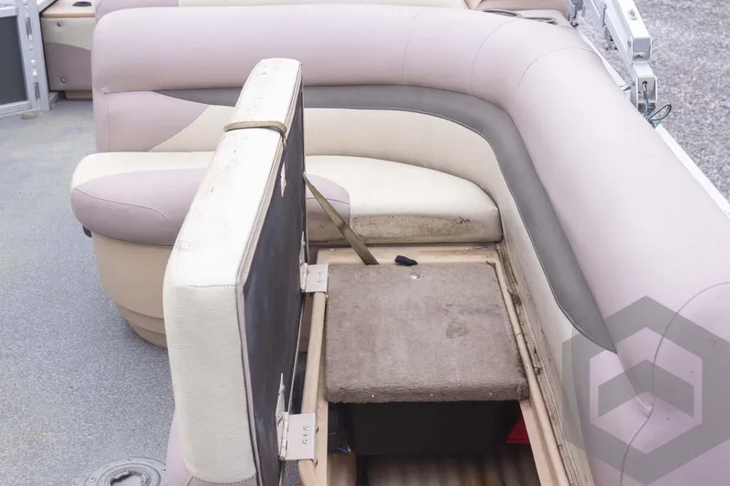 Slide: The Image of 2015 Sun Tracker Fishin' Barge 22 DLX interior seating with storage compartment open. - 22