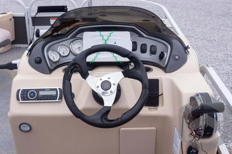 Slide: The Image of 2015 Sun Tracker Fishin' Barge 22 DLX dashboard with steering wheel and controls. - 23