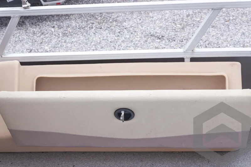 Slide: The Image of 2015 Sun Tracker Fishin' Barge 22 DLX storage compartment with beige upholstery. - 29