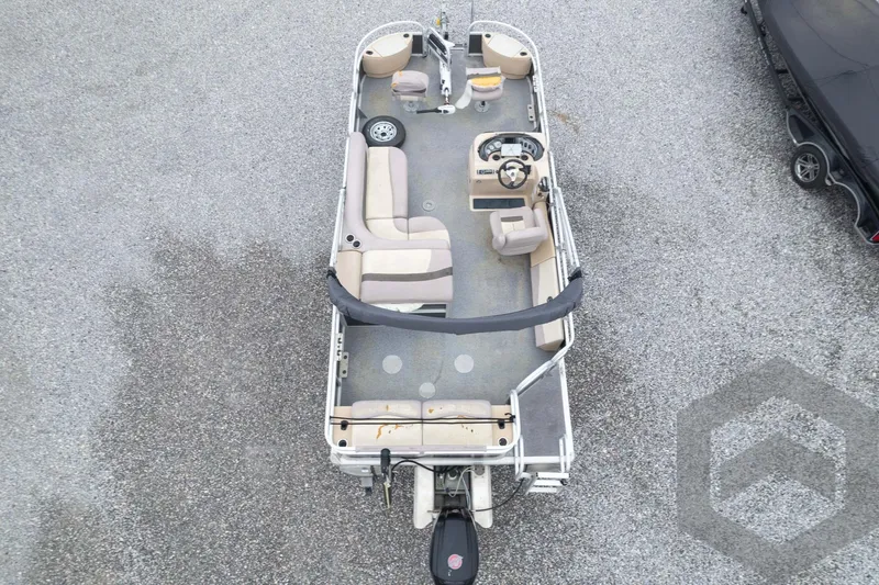 Slide: The Image of 2015 Sun Tracker Fishin' Barge 22 DLX pontoon boat, aerial view, parked on gravel. - 38