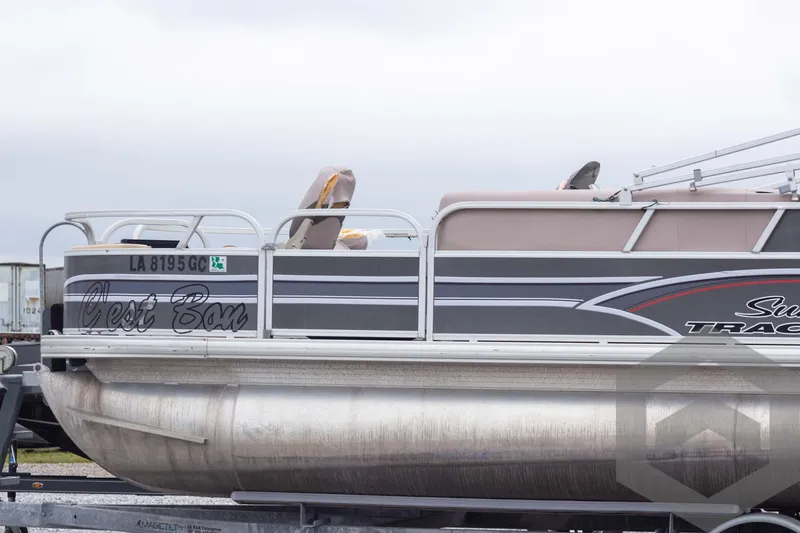 Slide: The Image of 2015 Sun Tracker Fishin' Barge 22 DLX pontoon boat on trailer, side view. - 9