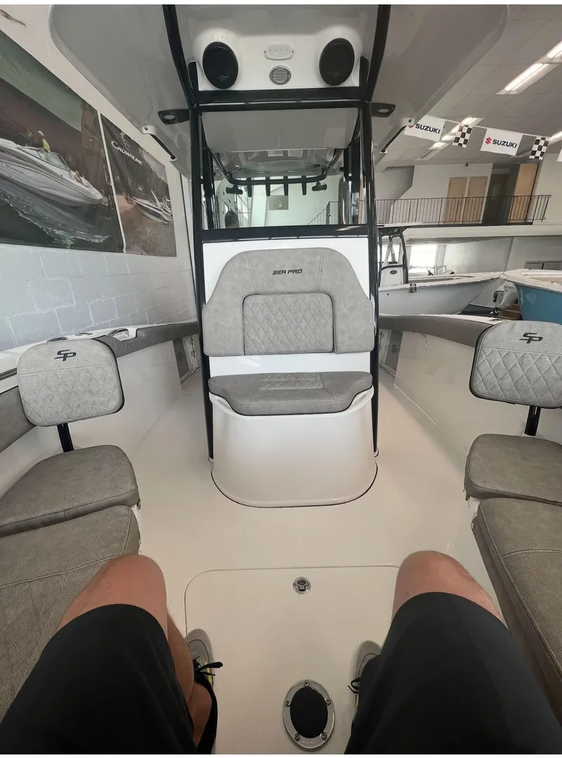 Slide: The Image of 2022 Sea Pro 239 Center Console boat interior with gray seating in showroom. - 3